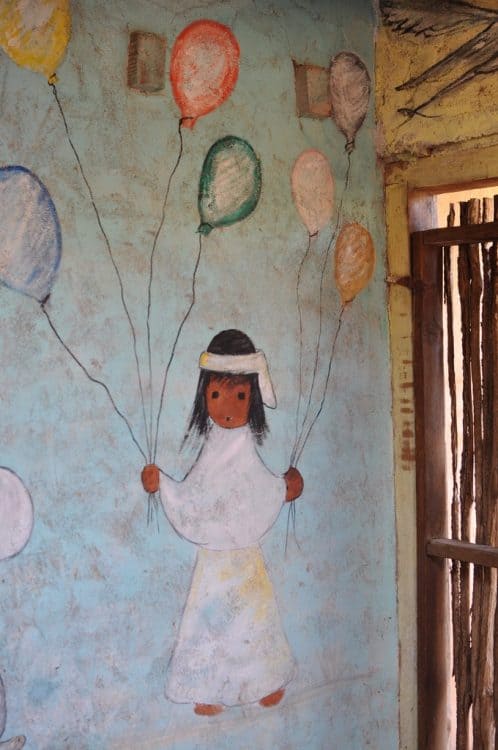 child with balloons by DeGrazia